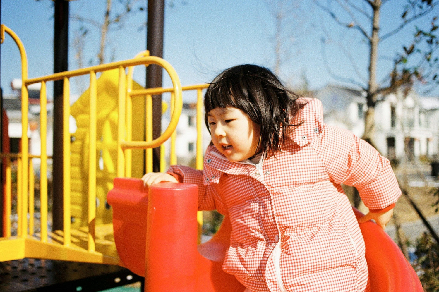 Toddler-playing-on-a-balance-beam-to-develop-gross-motor-skills